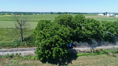 An-Aerial-View-of-Thomas-the-Tank-Engine-Blowing-Smoke-Arriving-by-It's-Self-Traveling-Over-the-Farmlands-and-Countryside-on-a-Beautiful-Day