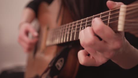 Acoustic-guitar-fretboard-and-hand-playing-chords,-close-up-view-with-no-face
