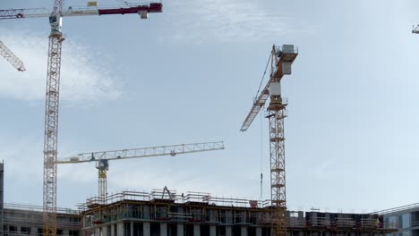 Tower-Cranes-At-Work-In-A-Construction-Site-At-Daytime