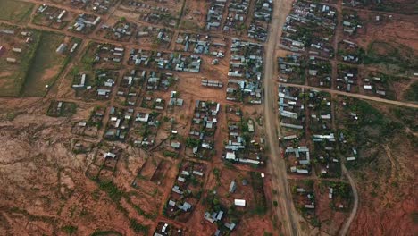 Large-remote-town-in-the-middle-of-Ethiopia,-buildings-with-metalic-roofs,-aerial-urbanism-scene-from-Africa