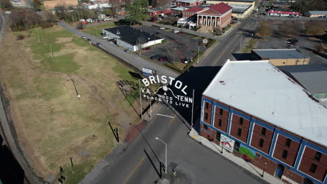 Aerial-View-of-Bristol-City,-Tennessee-and-Virginia-Bordertown,-Landmark-Sign-Above-State-Street-and-Cityscape,-Revealing-Drone-Shot