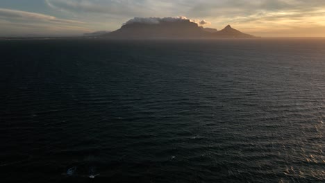 Epic-cinematic-drone-reveal-shot-over-Atlantic-of-iconic-Table-Mountain