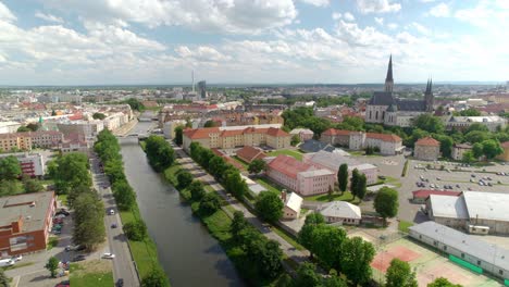The-panorama-of-the-city-Olomouc-with-historic-buildings-and-a-flowing-river-on-a-sunny-day-is-an-attractive-attraction-for-travelers-and-visitors,-Czech-Republic---Aerial-drone-shot