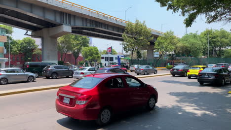 Busy-Traffic-Going-Past-In-Mexico-City-Beside-Overpass-On-Sunny-Day