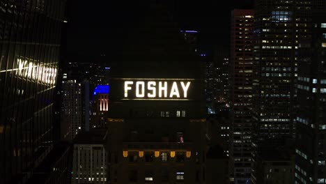 Aerial,-close-up-of-Foshay-Tower-in-downtown-Minneapolis-at-night