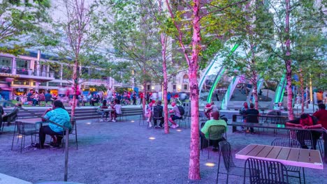 Many-visitors-enjoy-dining-in-the-outdoor-tables-of-the-ATT-Discovery-District-in-Dallas,-Texas