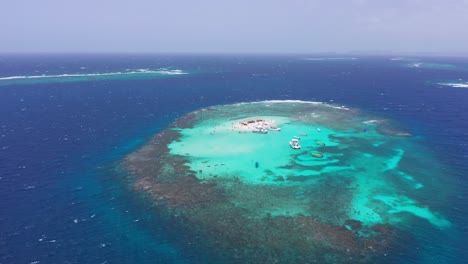 Stunning-aerial-arc-of-Caribbean-coral-islet-with-sandbank,-Cayo-Paraiso