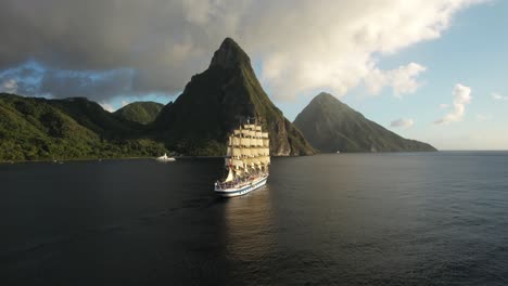 The-Royal-Clipper-sailing-along-Saint-Lucia's-beautiful-coast,-with-the-Pitons-in-the-background