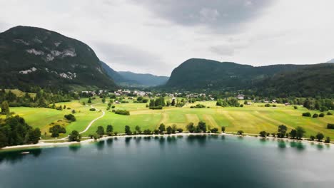 Drone-approach-lake-bohinj-Slovenia-tourist-destination,-scenery-valley-with-alps-mountains