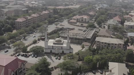 Aerial---Drone-shot-moving-forward-across-houses-and-mosque