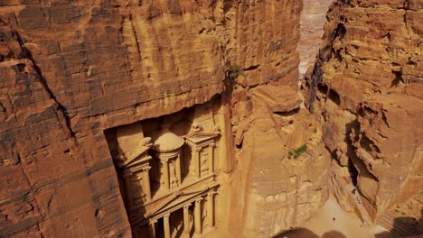 Historic-UNESCO-heritage-site-Khaznet,-the-Treasury-carved-into-sandstone-at-Petra,-Jordan-seen-from-a-viewpoint-above