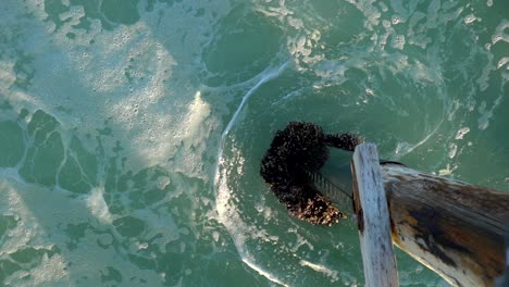 Slow-motion-footage-of-ocean-waves-hitting-a-pier-pillar