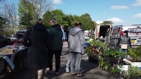 Bargain-hunters-browsing-busy-British-weekend-car-boot-sale-for-cheap-unwanted-goods