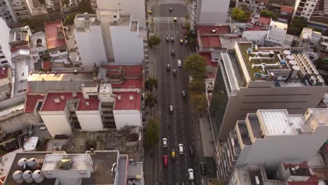 Aerial-tracking-shot-of-traffic-movement-on-road-amidst-tall-buildings-at-Cordoba-Avenue-in-Buenos-Aires