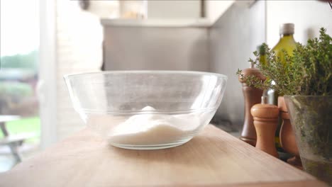 Person-taking-away-his-vintage-cooking-scale-to-mix-the-ingredients-in-the-bowl