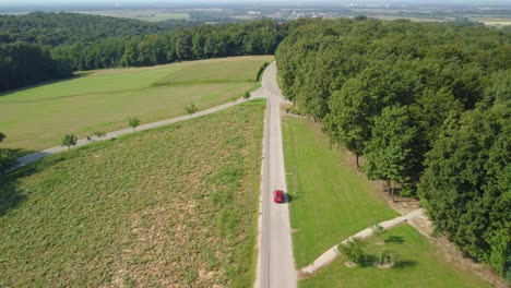 A-drone-tracking-the-car-on-the-road-in-the-forest-area