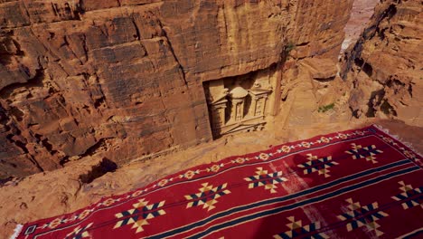 Historic-UNESCO-heritage-site-the-Treasury-Khaznet-carved-into-sandstone-at-Petra,-Jordan-seen-from-a-viewpoint-above