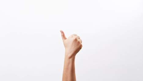 Close-up-of-Woman's-hands-showing-and-making-thumb-up-sign-isolated-on-a-white-studio-background-with-copy-space-for-place-a-text,-message-for-advertisement-and-product-promotional