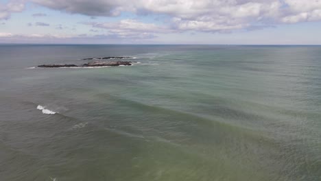 Drone-shot-of-a-house-on-an-island-off-Black-Rock-Beach-in-Cohasset,-MA