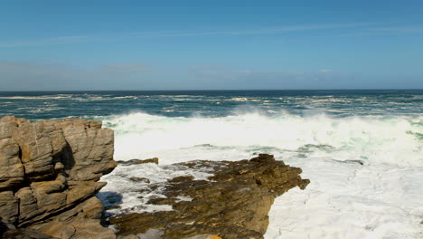 Wave-crash-into-rocks-with-big-white-splash,-rugged-Atlantic-coastline