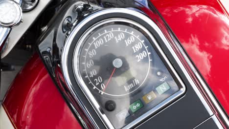 Vintage-Bike-Speedometer-Slow-Motion,-Motorcycle-Mileage-indicator-Clock,-Milo-meter,-odometer,-Topdown-view,-classic-style-Scooter-Vehicle-red-black-paint,-stop-lights-fuel-status