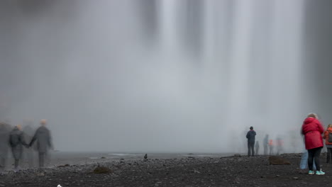 Crowds-of-tourists-at-Skogafoss-Waterfall-Iceland,-close-up-time-lapse