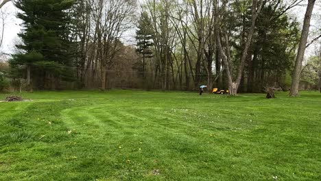 Time-Lapse-Footage-of-Mowing-Grass-on-a-Cub-Cadet-Lawn-Mower-With-Trees-and-Picking-up-Branches-in-Yard