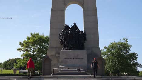 The-National-War-Memorial-in-Ottawa,-Canada-before-Canada-Day-2022-on-a-sunny-summer-day-with-military-police-in-frame