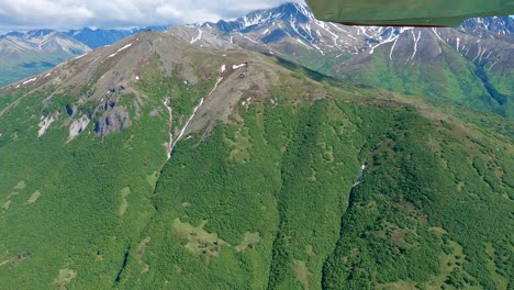 Small-airplane-flight-over-a-remote-mountain-ridge-in-the-Talkeetna-Range-of-Alaska,-east-of-the-town-of-Palmer