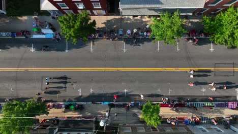 Top-down-aerial-of-spectators-watching-holiday-parade-in-USA