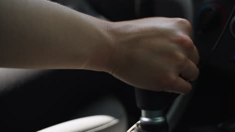 Woman's-hand-reaches-into-frame-and-shifts-gears-on-manual-transmission