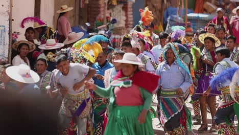 Weitwinkelaufnahme-Beim-Jährlichen-Tinku-Festival,-Bei-Dem-Menschen-In-Zeremonieller-Und-Farbenfroher-Kleidung-Auf-Der-Straße-In-Bolivien-Laufen-Und-Tanzen
