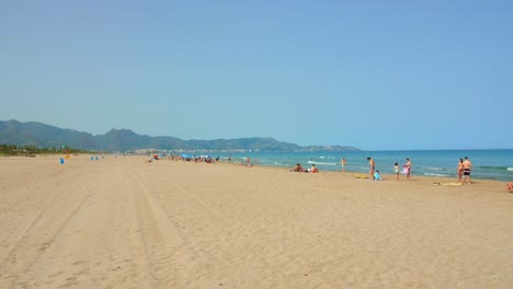 Tourists-On-The-White-Sand-Beach-Of-El-Grau-Near-Moncofa,-Castellon-Spain