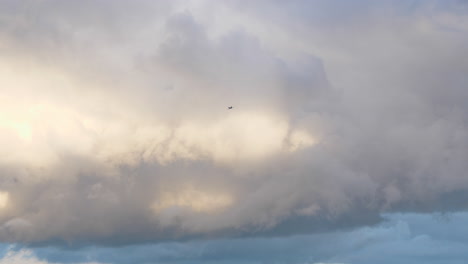 Scene-of-clouds-in-sky-and-plane-passing-by