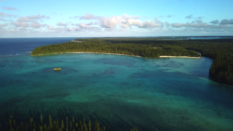 Oro's-Bay-in-the-Isle-of-Pines-in-New-Caledonia---pull-back-aerial-view-of-a-tropical-paradise