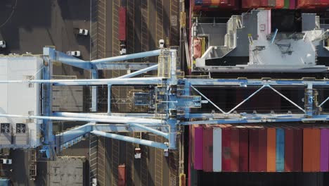 Top-down-View-Of-Port-Crane-And-Cargo-Containers-At-The-Husky-Terminal,-Tacoma-Port-In-Washington,-USA---aerial-drone-shot