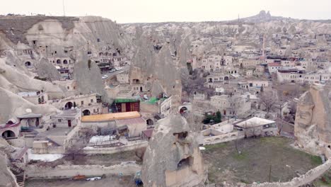 Goreme-town-with-mosque-and-residences-in-rock-formations,-Cappadocia-region,-Turkey