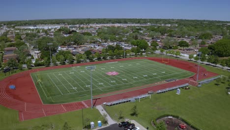 Aerial-drone-shot-over-an-empty-football-field-in-Salvation-Army-Sports-Complex,-South-Chicago,-USA-on-a-bright-sunny-day