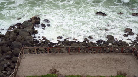 Waves-crashing-on-a-rocky-coastline-in-San-Bartolo,-Lima,-Peru