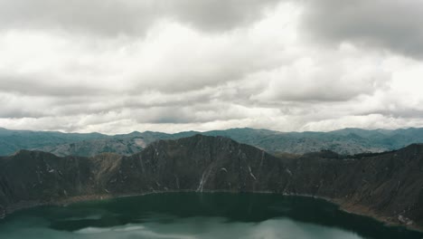 Drone-Flyover-Hikers-On-Top-Of-Quilotoa-Loop-Overlooking-The-Lagoon-In-Ecuador