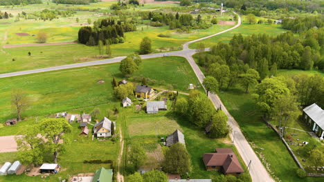 Aerial-View-of-Rural-Village-in-Countryside-of-Lithuania,-Homes-and-Farming-Land-on-Summer-Season,-Drone-Shot