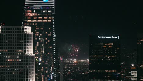 Firework-display-in-the-distance-behind-skyscrapers-of-downtown-LA