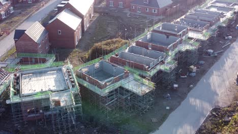 Aerial-view-above-suburban-townhouse-framework-development-construction-site-at-sunrise