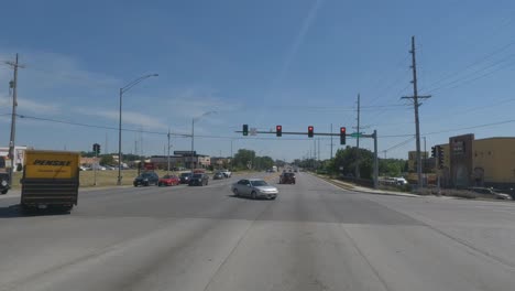 Traveling-in-the-Chicago-Illinois-area,-suburbs,-streets,-and-highways-in-POV-mode-at-red-light