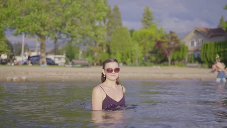 Young-attractive-girl-in-sunglasses-playing-in-the-water