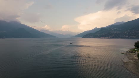 Ferry-Boat-on-Waters-of-the-Beautiful-Lake-Como,-Italy-at-Sunset,-Aerial