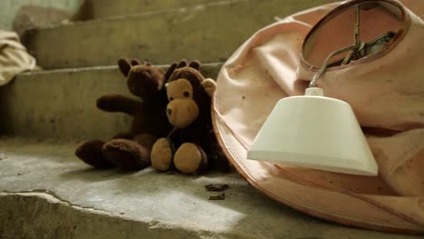 Slowmotion-shot-in-abandoned-house-in-a-lonely-village-with-toymoose-and-teddybear-on-the-stairs