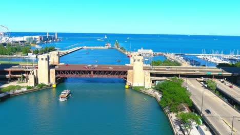 Aerial-flyby-overlooking-riverwalk-and-lake-Michigan-in-Chicago-Illinois-|-Navy-pier-in-the-background-|-Afternoon-lighting