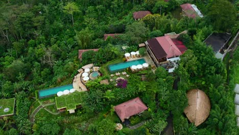aerial-pan-down-of-a-beautiful-pool-at-a-resort-in-Munduk-Bali-Indonesia
