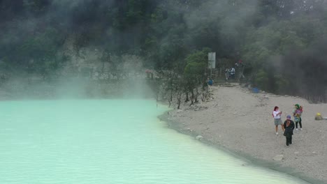 aerial-of-Kawah-Putih-sulfur-lake-in-Bandung-with-tourists-standing-at-shoreline
